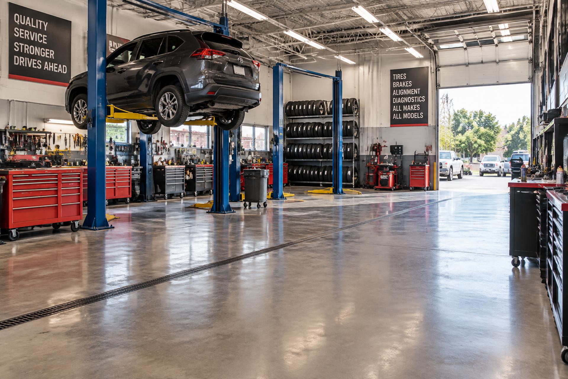 Bright D&S Auto Repairz workshop with vehicle lifts, red tool chests and clean service bays